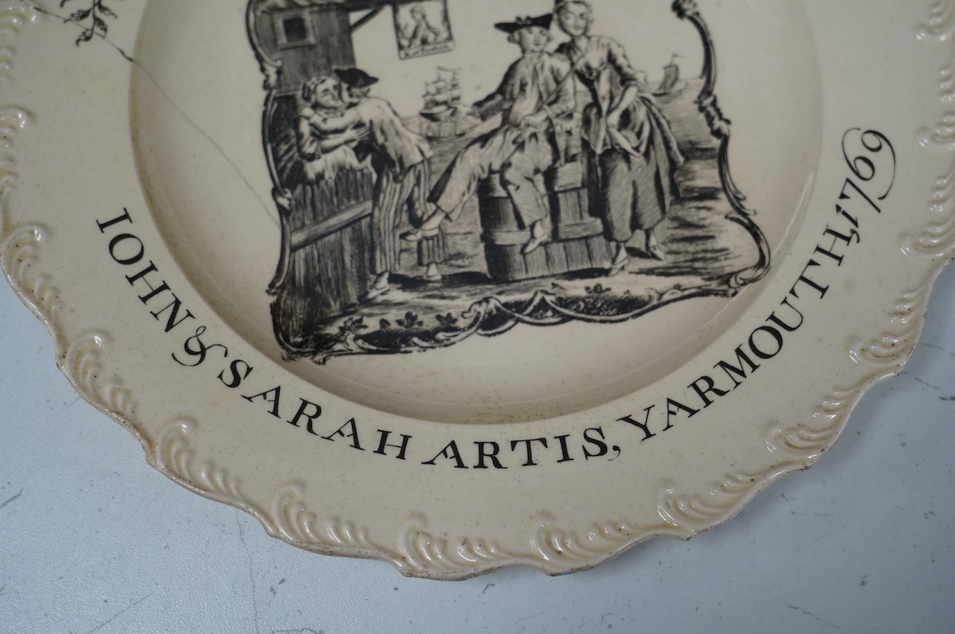 A George III documentary creamware plate, printed by Sadler, black enamelled inscription ‘John and Sarah Artis, Yarmouth 1769’, a further of example in the National Maritime Museum Greenwich (https://www.rmg.co.uk/collec